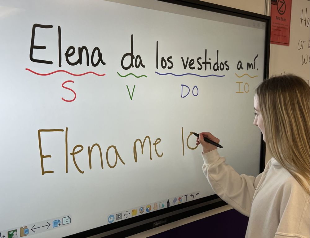 Photo of student writing on a large screen