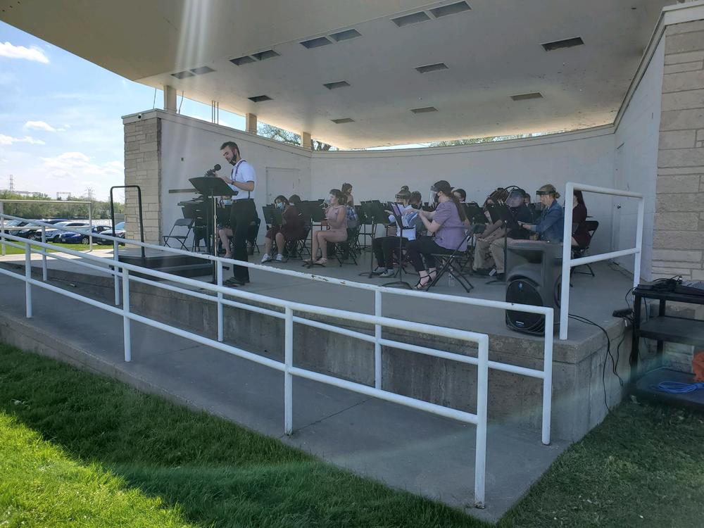 Picture of band students and teachers in band shell