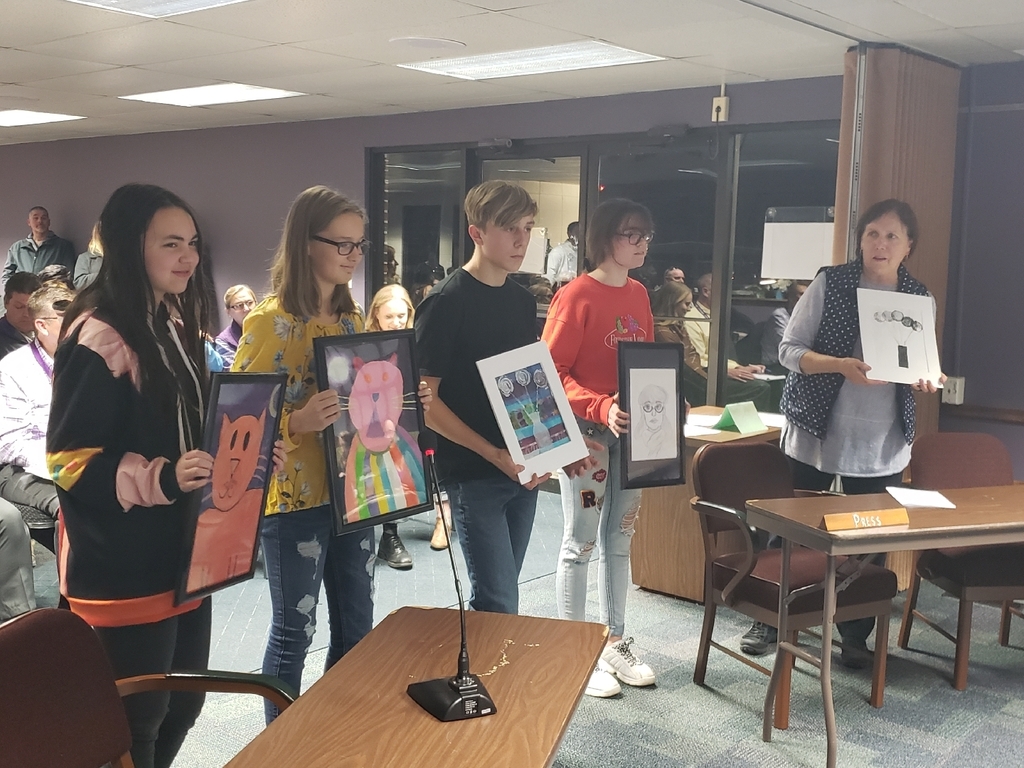 Mrs. Hamer and 4 students with their artwork 