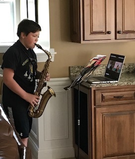 Owen L. receiving band lesson through Zoom with Mr. Carter